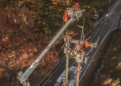 Workers from USA work on a project in Pelham, NH installing spacer cable.